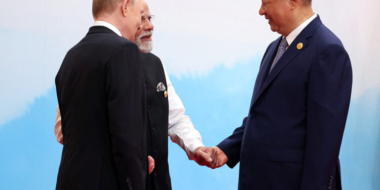 China’s Xi pushes a new global order, flanked by leaders of Russia and India