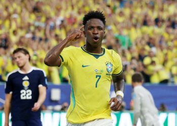 Soccer-Vinicius fires Brazil into World Cup knockouts with 3-0 win over Scotland