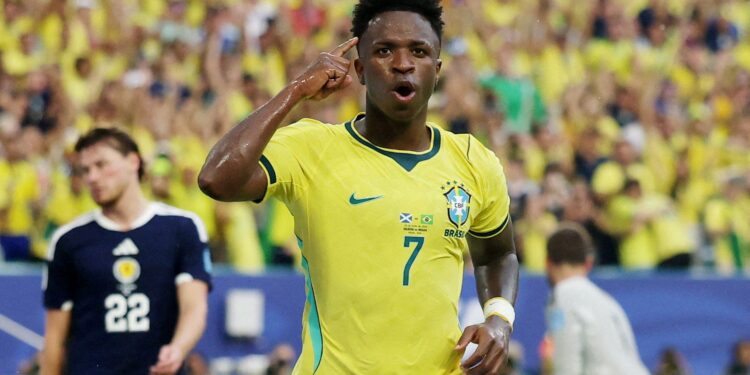 Soccer-Vinicius fires Brazil into World Cup knockouts with 3-0 win over Scotland